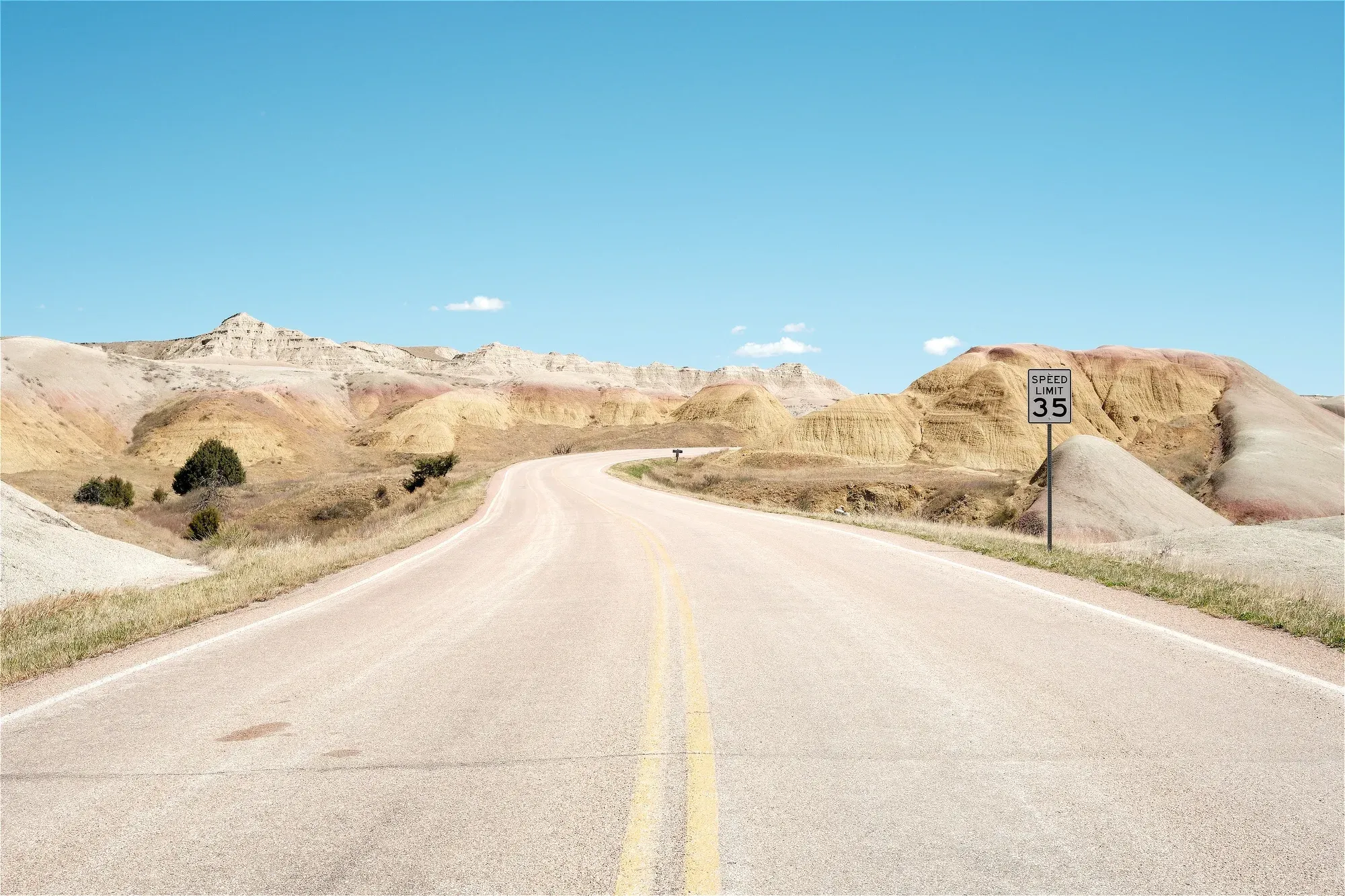 Badlands empty road speed sign