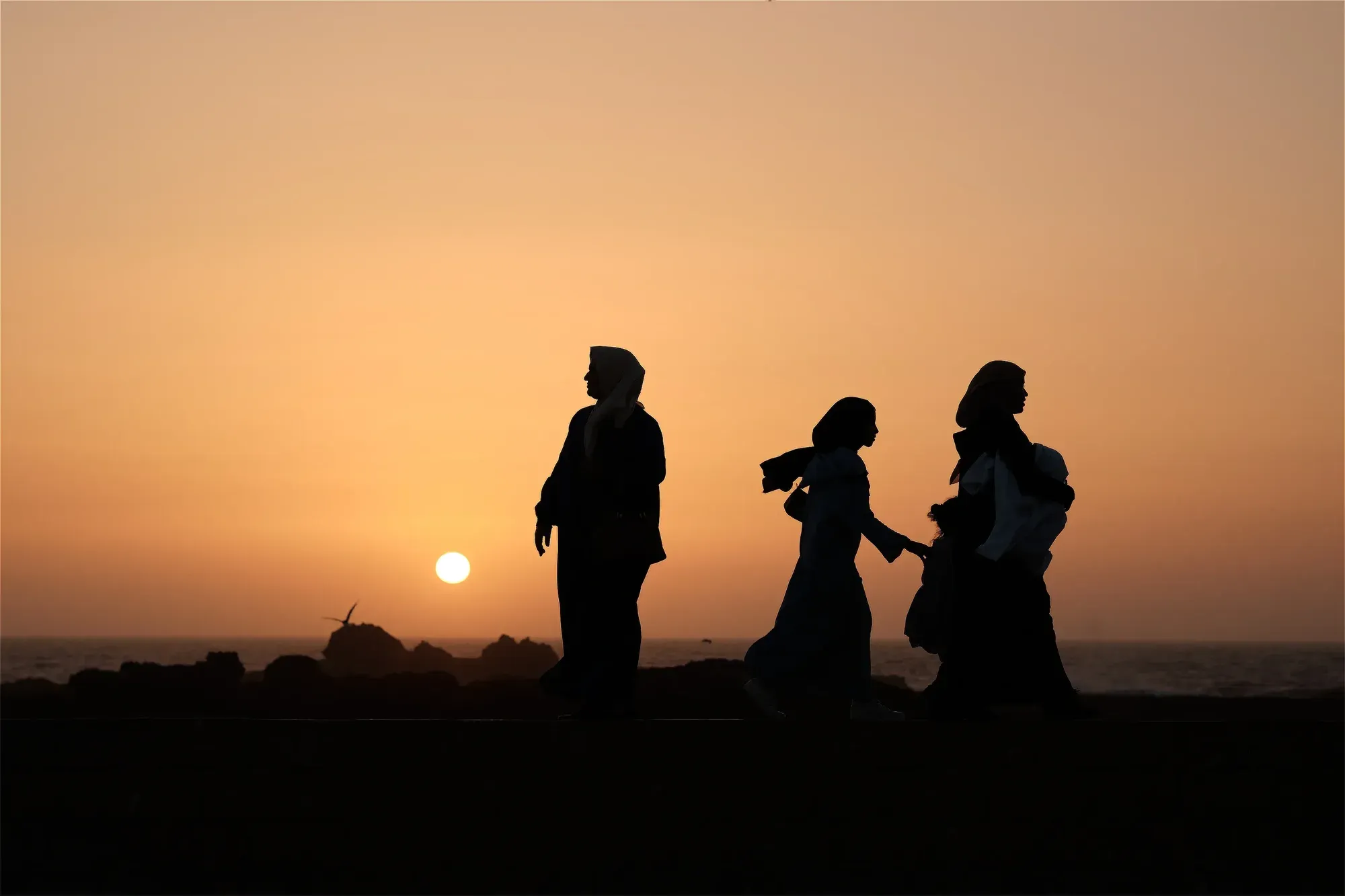 Women silhouettes sunset walk